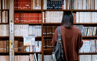 A foreigner studying abroad standing in a library