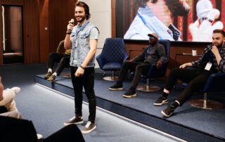 Public Speaking: A man confidently delivers a business presentation using a microphone in a conference room.